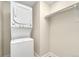 Efficient laundry area with a stacked washer and dryer set and ample storage space at 1827 N Grant St # 604, Denver, CO 80203