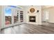 Inviting living room with fireplace and access to a balcony via stylish French doors at 1827 N Grant St # 604, Denver, CO 80203