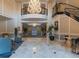 Elegant lobby with a grand chandelier, staircase, and seating area at 1827 N Grant St # 604, Denver, CO 80203