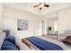 Bright main bedroom with a ceiling fan, neutral decor, and a cozy seating area at 1827 N Grant St # 604, Denver, CO 80203
