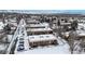 Winter aerial view of apartment buildings with mountain views in the distance at 3663 S Sheridan Blvd # P1, Denver, CO 80235