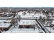 Aerial view of neighborhood apartment building with snow, near intersection and park at 3663 S Sheridan Blvd # P1, Denver, CO 80235