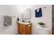 Bathroom featuring a single sink vanity with modern fixtures and coordinated towel racks at 3663 S Sheridan Blvd # P1, Denver, CO 80235