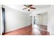 Bedroom with hardwood floors, mirrored closet, and ceiling fan for comfortable living at 3663 S Sheridan Blvd # P1, Denver, CO 80235