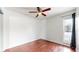 Bedroom with wood floors and ceiling fan, providing comfort and style at 3663 S Sheridan Blvd # P1, Denver, CO 80235