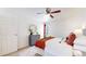 Bright bedroom features a ceiling fan, stylish furnishings, and balcony access at 3663 S Sheridan Blvd # P1, Denver, CO 80235
