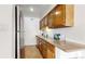 Well-maintained kitchen featuring wood cabinets, stainless refrigerator, and granite countertops at 3663 S Sheridan Blvd # P1, Denver, CO 80235