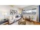Bright living room featuring a comfortable sofa, stylish decor, and large windows at 3663 S Sheridan Blvd # P1, Denver, CO 80235