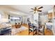 Open-concept living and dining area with wood floors and ample natural light at 3663 S Sheridan Blvd # P1, Denver, CO 80235