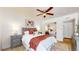 Comfortable bedroom with a plush bed, ceiling fan, and a mirrored closet, and a large area rug at 3663 S Sheridan Blvd # P1, Denver, CO 80235