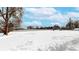 Snow-covered street with nearby houses, showcasing the winter landscape at 3663 S Sheridan Blvd # P1, Denver, CO 80235
