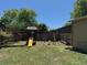 Backyard featuring a wooden playset, swing set, mature trees, and a spacious grassy area at 16753 E Ithaca Pl, Aurora, CO 80013