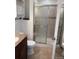 Well-lit bathroom with a tiled shower and granite vanity at 16753 E Ithaca Pl, Aurora, CO 80013