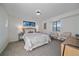 Cozy bedroom with carpet, two windows, and accent furniture at 7590 S Reed Ct, Littleton, CO 80128