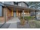 Inviting front porch with brick accents, leading to the front door, showcasing curb appeal at 7590 S Reed Ct, Littleton, CO 80128