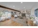 Bright living room with fireplace, hardwood floors, and ample natural light at 7590 S Reed Ct, Littleton, CO 80128