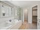 Elegant bathroom with soaking tub, tiled shower, and ample natural light at 6468 S Forest St, Centennial, CO 80121