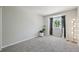 Spacious bedroom with gray carpet, neutral walls and a modern floor lamp for ambient lighting at 6468 S Forest St, Centennial, CO 80121