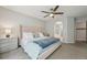 Serene bedroom featuring a plush bed, ceiling fan, and arched doorway leading to the Primary bath at 6468 S Forest St, Centennial, CO 80121