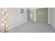 Bright bedroom with gray carpet, neutral walls and a modern floor lamp with a unique design at 6468 S Forest St, Centennial, CO 80121