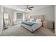 Bright, comfortable bedroom with large window, soft carpet, and an elegant upholstered bed at 6468 S Forest St, Centennial, CO 80121