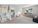 Bright bonus room with gray carpet and a comfortable sofa near a window overlooking the yard at 6468 S Forest St, Centennial, CO 80121