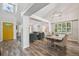 Open-concept dining room showcasing hardwood floors and access to the living room at 6468 S Forest St, Centennial, CO 80121