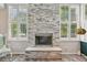 Modern fireplace with stone surround and ample natural light at 6468 S Forest St, Centennial, CO 80121