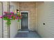 Inviting front entrance featuring a hanging basket of flowers and brick accents at 6468 S Forest St, Centennial, CO 80121