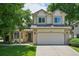 Charming two-story home with well-manicured lawn, mature trees and a spacious two-car garage at 6468 S Forest St, Centennial, CO 80121