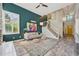Bright living room featuring a colorful accent wall and staircase at 6468 S Forest St, Centennial, CO 80121