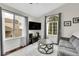 Bright living room with hardwood floors, vaulted ceiling, and large windows at 5661 E Melody Way, Castle Rock, CO 80104