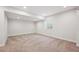 Spacious carpeted basement with recessed lighting and a well for natural light at 5583 Riverbend Ave, Firestone, CO 80504