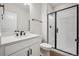 Bathroom includes a shower with black hardware, single vanity, and modern fixtures at 5583 Riverbend Ave, Firestone, CO 80504