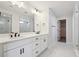 Bathroom features double vanity, and a glass-enclosed shower with marble-look tile at 5583 Riverbend Ave, Firestone, CO 80504