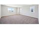 Light-filled bedroom offers neutral carpeting and ample space for relaxation at 5583 Riverbend Ave, Firestone, CO 80504