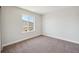 Bedroom showcases neutral colors and large windows, providing natural light at 5583 Riverbend Ave, Firestone, CO 80504