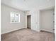 Bright bedroom with carpeted floor, closet, and natural light from the window at 5583 Riverbend Ave, Firestone, CO 80504