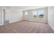 Spacious bedroom with large windows offers plenty of natural light and neutral carpeting at 5583 Riverbend Ave, Firestone, CO 80504