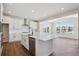 Modern kitchen with a large island, stainless steel appliances, and bright white cabinetry at 5583 Riverbend Ave, Firestone, CO 80504