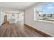 Bright room with an inviting view of the kitchen and abundant natural light through a large window at 5583 Riverbend Ave, Firestone, CO 80504