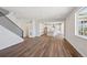 Spacious living area showcases seamless flow to the kitchen and modern staircase design at 5583 Riverbend Ave, Firestone, CO 80504