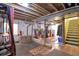 Unfinished basement with an exposed ceiling and ductwork and a washer and dryer hook-up at 1801 Aspen St, Fort Lupton, CO 80621