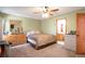 Well-lit bedroom featuring neutral carpet, a ceiling fan, and a coordinating comforter set at 1801 Aspen St, Fort Lupton, CO 80621