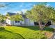 Charming single-Gathering home featuring a lush front lawn, mature trees, and a welcoming entrance at 1801 Aspen St, Fort Lupton, CO 80621