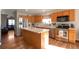 Well-equipped kitchen with stainless steel appliances, an island, and ample cabinet space at 1801 Aspen St, Fort Lupton, CO 80621