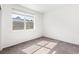 Bright, empty bedroom with a large window and neutral carpet at 5444 Zephyr St # 203, Arvada, CO 80002