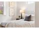 Bright bedroom with neutral decor, plush bedding, and soft natural light at 5444 Zephyr St # 203, Arvada, CO 80002