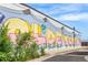 Charming mural on a building in the Olde Town neighborhood featuring colorful lettering at 5444 Zephyr St # 203, Arvada, CO 80002