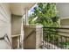 View of the home's front entrance, featuring a staircase and a green exterior and potted plant at 5444 Zephyr St # 203, Arvada, CO 80002